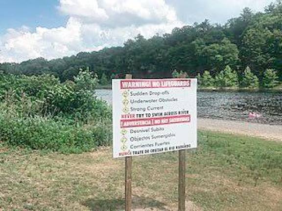 <b>Signs at Milford Beach warn that there are no lifeguards, and that the river presents significant risks. (NPS photo)</b>