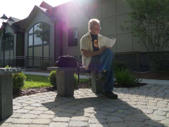 Don't forget the library A patron reads outside the Milford branch of the Pike County Library (Photo by Charles Reynolds)