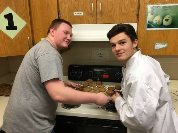 Integrated class bakes and sings for nursing home residents Pictured baking cookies are Juniors Brendan Heaney (left) and Anthony Catalano (Photo provided)
