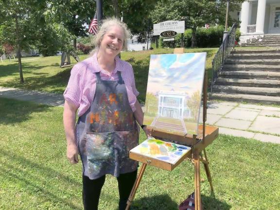 Artist Susan Miiller and her 2019 painting of the Columns Museum