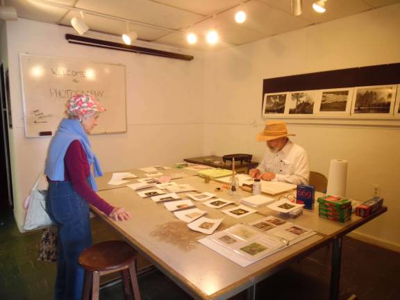 Locals get crafty Joan Adams from Sussex County talks with Fellow Ray Yaros about his art. He's painting over photos of wildflowers.