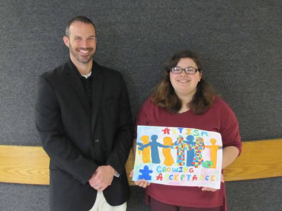 Posters raise autism awareness Pictured (from left): high school principal Dr. Brian Blaum and senior Cassandra Hoffman (Photo provided)