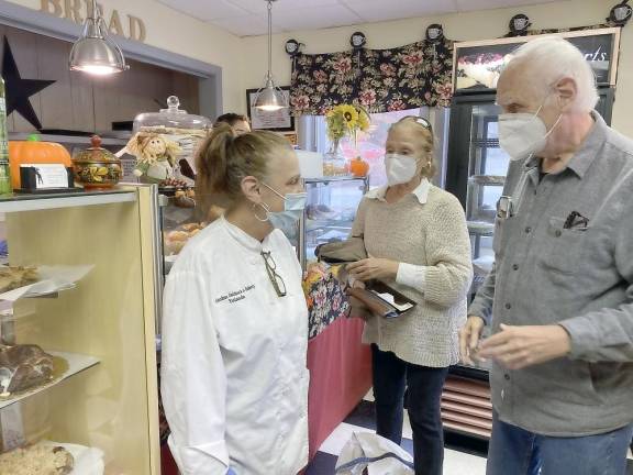 Grandma Goldsack (left) with Suzanne and Bob Levine buying a bunch of goodies (Photo by Marilyn Rosenthal)