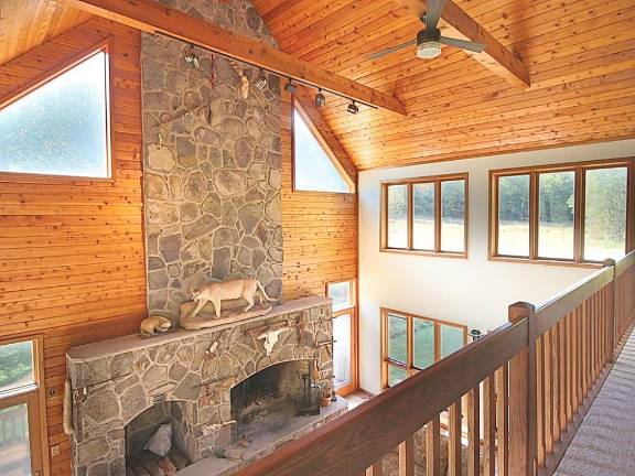 Mountaintop equestrian estate includes modern home and pond Fireplace