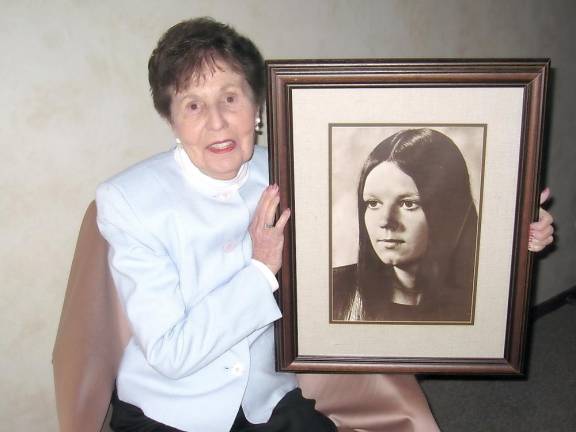Julia Duane Quinlan, hospice pioneer, celebrates 95th birthday Julia Quinlan with a portrait of her daughter, Karen Ann (Photo provided)