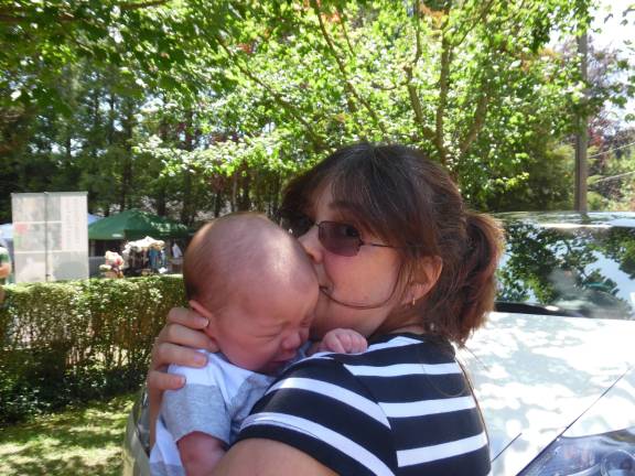 Terror at the farmers market Elizabeth Mallard of Milford with her five-week old baby, who was in the car when it was hit. (Photo by Anya Tikka)