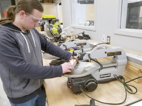 Alex Chopyk uses a scroll saw (Photo provided by Delaware Valley School District)