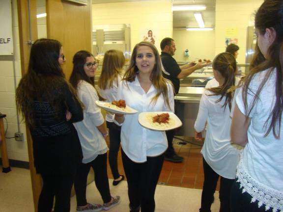 'Aladdin Jr.' dinner-theater delights senior citizens Alyssa Freymuth and Kamlia Alario look on while Tara Stevenson carries plates out to dinner guests (Photo provided)