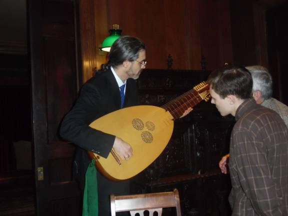 Baroque music at Grey Towers Daniel Swenberg shows theorbo to listeners after the performance.