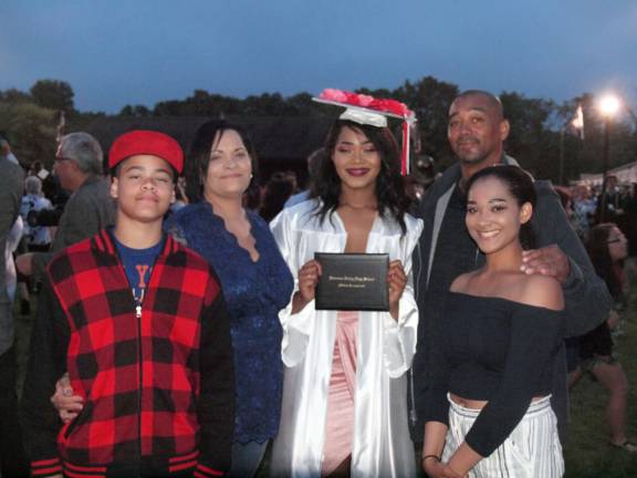 Graduate Cameron Irving poses with her family