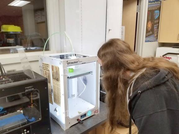 Stevie Hamilton works on a 3D printer (Photo provided by Delaware Valley School District)