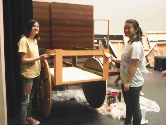 Curtain soon to go up on 'Fiddler' Shira Michel and Kayla Bicskei paint stage props (Photo by Anya Tikka)