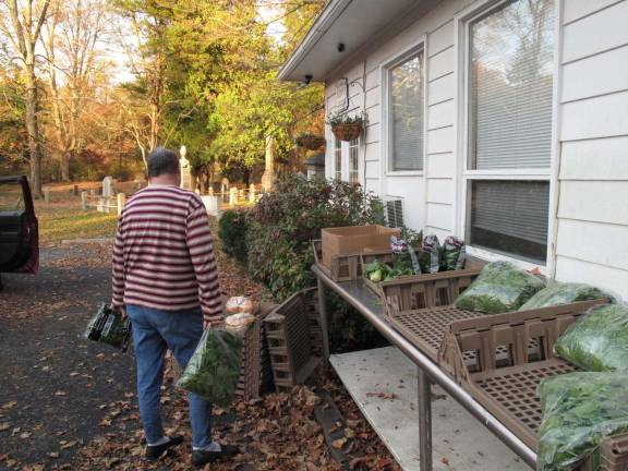 Shutdown story emerges with park's re-opening A local resident picks up supplies from the Bushkill Outreach Center, which provides food to people in need. (Photo by Jerry Goldberg)