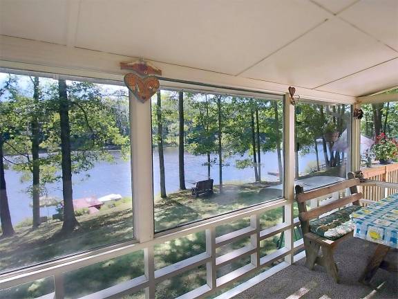 Lakefront ranch with private dock Screened-in porch