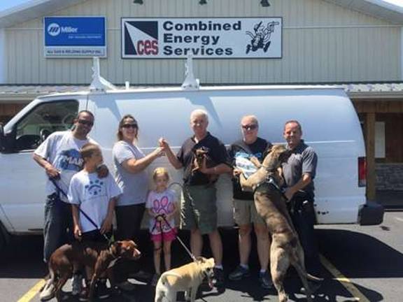 Combined Energy Services donates work van for animal rescue From left (top row): Julio Roman (Pibbles trainer), Saleena Hernandez (Pibbles founder), Mike Taylor (Combined Energy Services President), Bella (in Mike Taylor’s arms), Melissa Roberts (Pibbles puppy and expectant mother coordinator) and Chris Roberts (Combined Energy Services and Pibbles). Second row: Julio Roman, Jr. and Gabby of Pibbles. Third row: Gixxer, Dory, and Stella. (Photo provided)