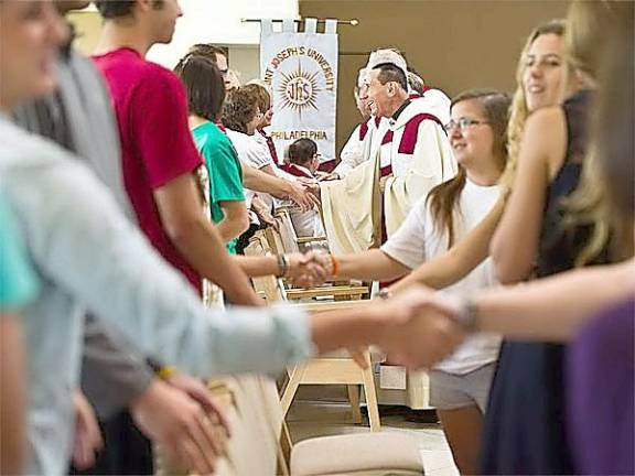 During flu season, parishioners will do the Sign of Peace (as pictured) without physical contact in the Diocese of Scranton, according to a directive by Bishop Bambera.