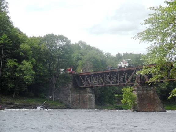 Bridge inspectors saved from river currents Rescue operation showing the cables attached to the crane on the bridge. (Photo by Anya Tikka)
