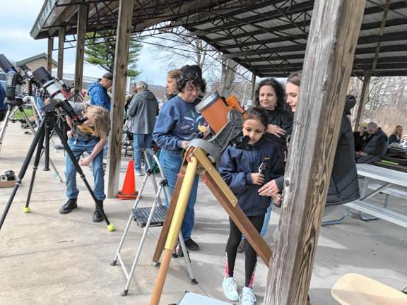 Residents look through telescopes set up at the Wallkill River National Wildlife Refuge in Sussex. (Photo by Kathy Shwiff)