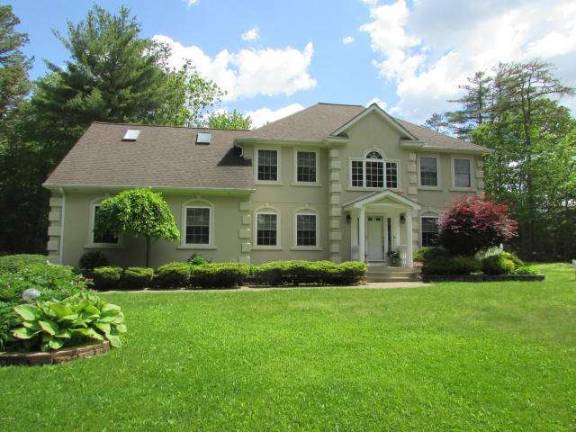 Upscale center hall colonial with pool