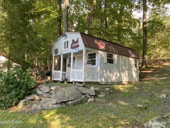 This private lakefront home features a dock, raft, and boathouse