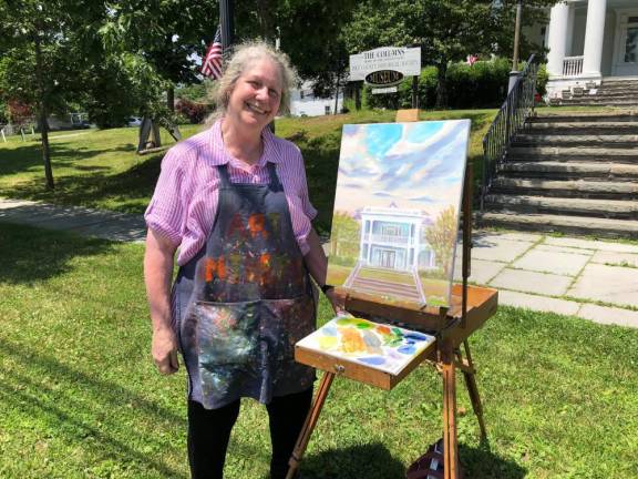 Artist Susan Miiller and her 2019 painting of The Columns Museum.