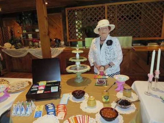 Modern Day Tea Party Catalano in front of a tasty spread.