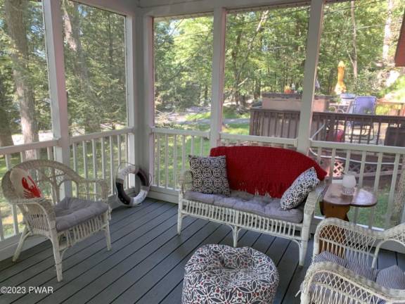 This private lakefront home features a dock, raft, and boathouse