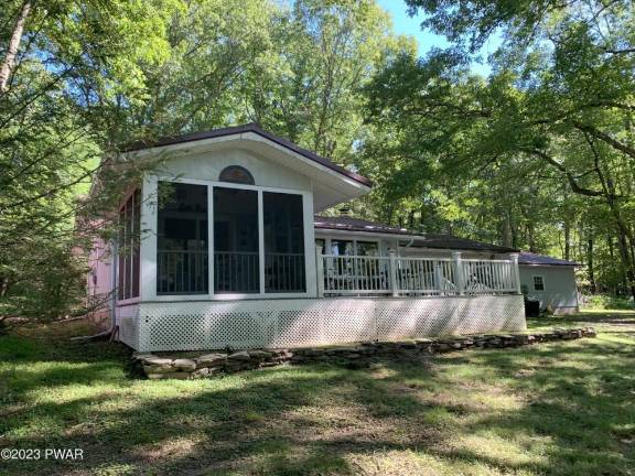 This private lakefront home features a dock, raft, and boathouse