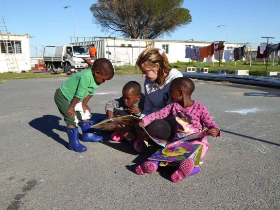 Lending a loving hand in South Africa Mary Bocskocsky reads to children in South Africa (Photo provided)