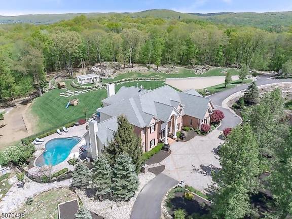 Home on five manicured acres has pool, movie theater