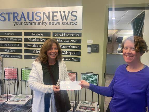 Reader wins $250 for shopping local Editor Lisa Reider, right, hands this week’s winner, Cathy Purtell, her $250 prize.