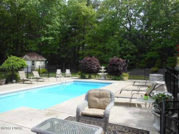 Upscale center hall colonial with pool
