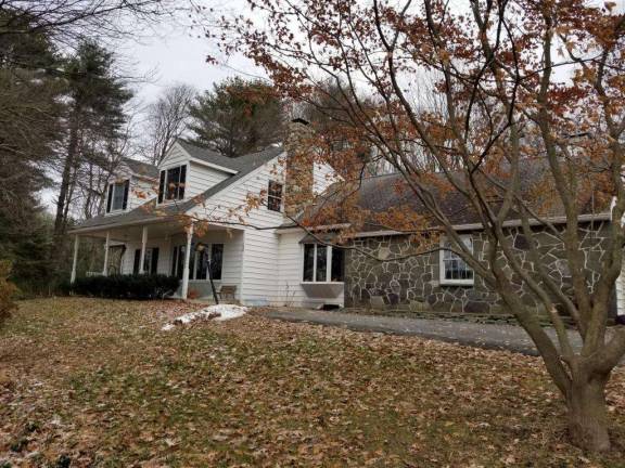 A stone-front colonial nestled in the woods A stone-front colonial nestled in the woods