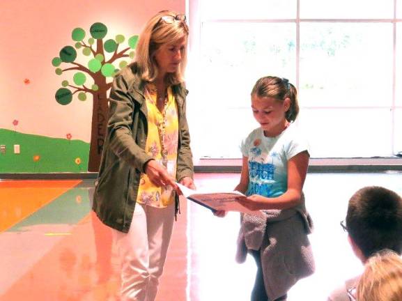 Mrs. Padgett with Alexandra Morton as she reads her journal.