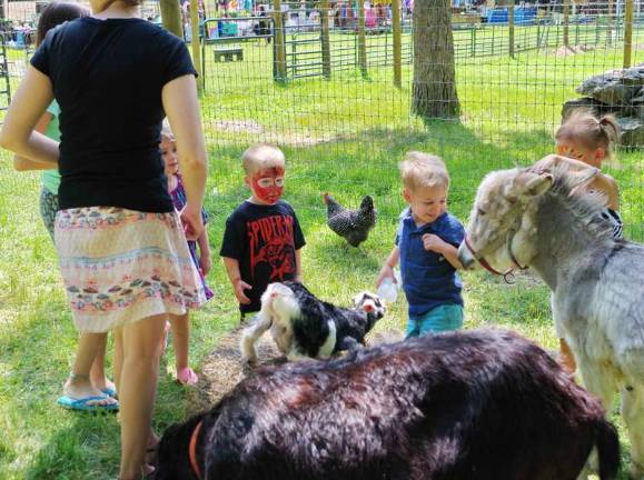 A Day at Country Ark Farm With a bottle two and a half year old Christopher Gillespie of Shohola feeds milk to a baby goat.