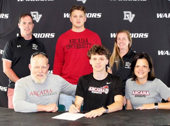 Senior DVHS volleyball player Trevor Johnson (front row, center) with his parents, Matt and Liz Johnson and head coach Adam Holdredge, brother Thomas Johnson and assistant coach Heather Holdredge.