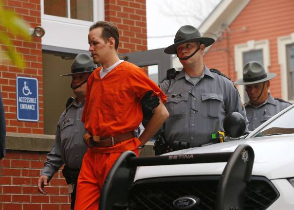 Eric Frein is escorted by police into the Pike County Courthouse for his arraignment in Milford, Pa., Friday Oct. 31, 2014. (AP Photo/Rich Schultz)