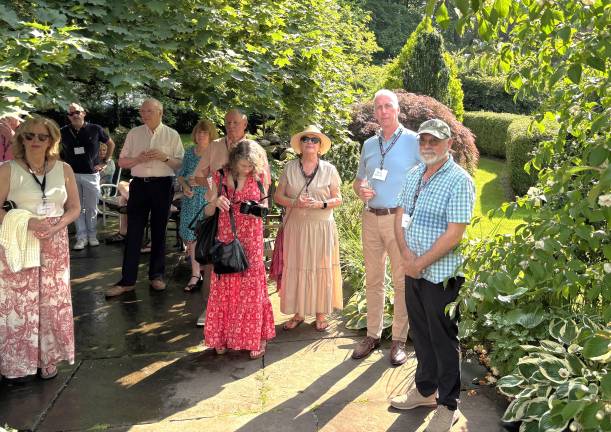 In the garden of Richard and Rebecca... Guests huddle in the shade at the Milford Readers and Writers festival Garden Party on June 22, 2025.