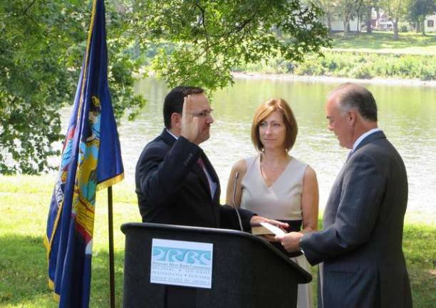 DRBC’s new Executive Director takes oath of office DRBC photo N.J. DEP Commissioner Bob Martin administers the oath of office to DRBC Executive Director Steve Tambini, with Steve's wife, Laura, holding the Bible. The ceremony took place along the Delaware River at Washington Crossing State Park in Titusville, N.J. on Aug. 14.