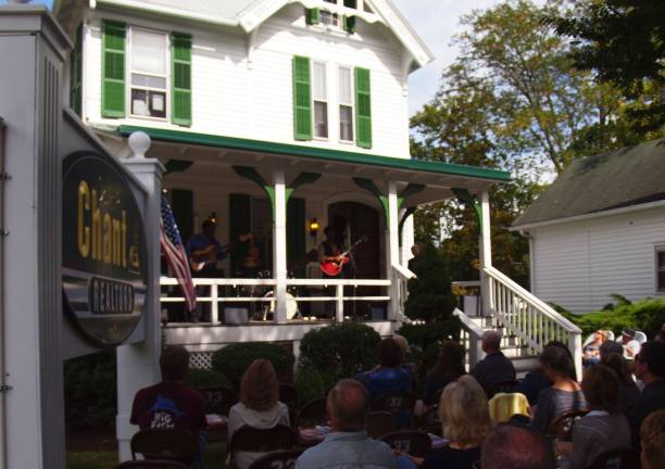Nothing says summer like the sounds of the Milford Music Festival The Milford Music Festival features 60-plus free performances at 30 venues, popping up on sidewalks and porches like that of the Davis R Chant Realtors office, pictured (Photo provided)