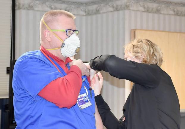 Dr. Stanley Skonieczki, medical director of the Wayne Memorial Hospital Emergency Department is vaccinated by Kristy Tirney, RN, against COVID-19 at the hospital in Honesdale (Photo provided)