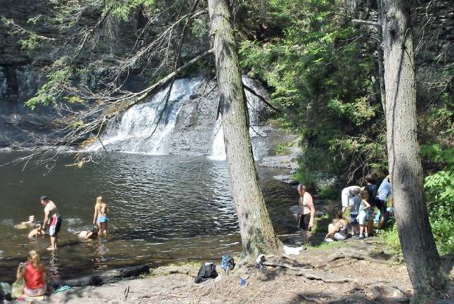 Visitors wade at Hackers Falls