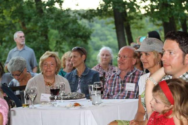 Community embraces Kitchen Garden Tour Guests watch as awards are handed out.