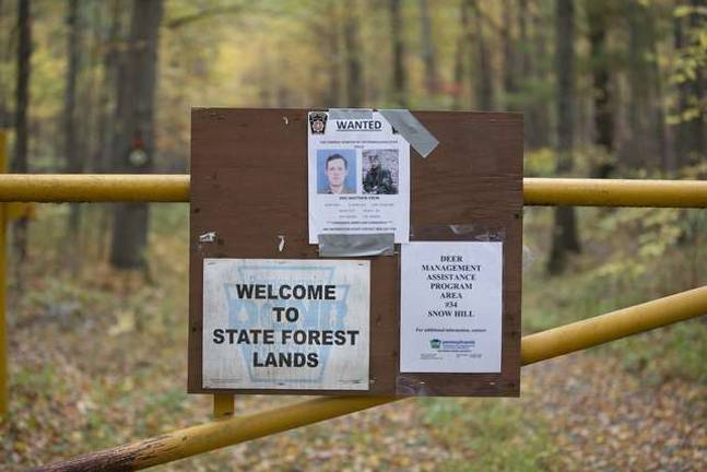Man hunt continues A Pennsylvania State Police wanted poster for Eric Matthew Frein is duct taped to a fire road gate at the Snow Hill Forest next to the Delaware State Forest.