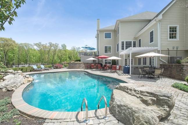 Home on five manicured acres has pool, movie theater