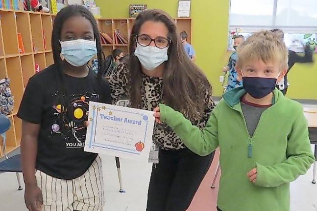 Winner of the Grades 3-5 Category: Miss Paz, third-grade teacher. Pictured (from left): Sekai Jones, Miss Paz, and Patrick Tamplin (Photo by Peg Snure)