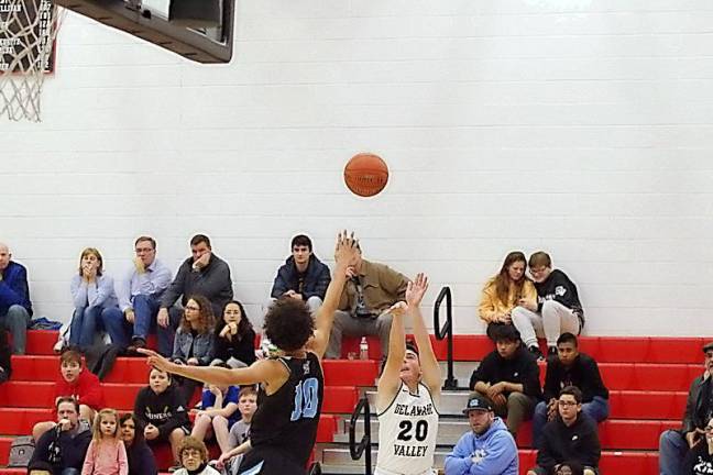 Delaware Valley's Mark Cavallaro launches the ball towards the hoop while covered by Wilkes-Barre's Cole Walker in the second quarter. Cavallaro scored 8 points.