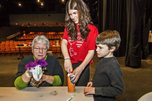 Sock puppet fun (L-R) Patricia Meacham of Matamoras, Pa., Managing Director of the Tri-State Actors Theatre at SCCC, Theatre member Lauren DeVore of Franklin and Jason Cahill, 8, of Vernon at the Sock puppet making event.