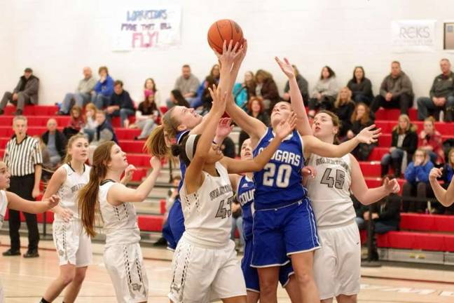 Lady Cougars top Lady Warriors in holiday basketball tourney Hands reach for the ball during a rebound. (Photo by George Leroy Hunter)