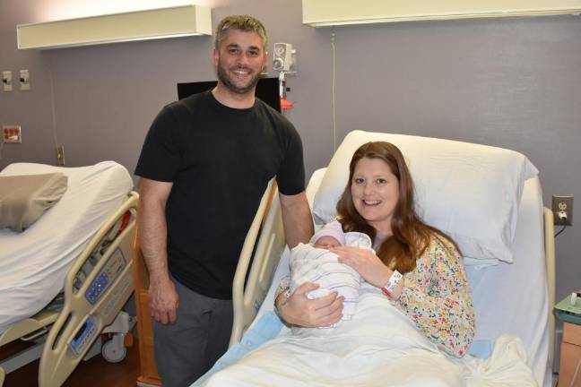 Matthew and Erika Adames with their Leap Year baby, Ainsley.